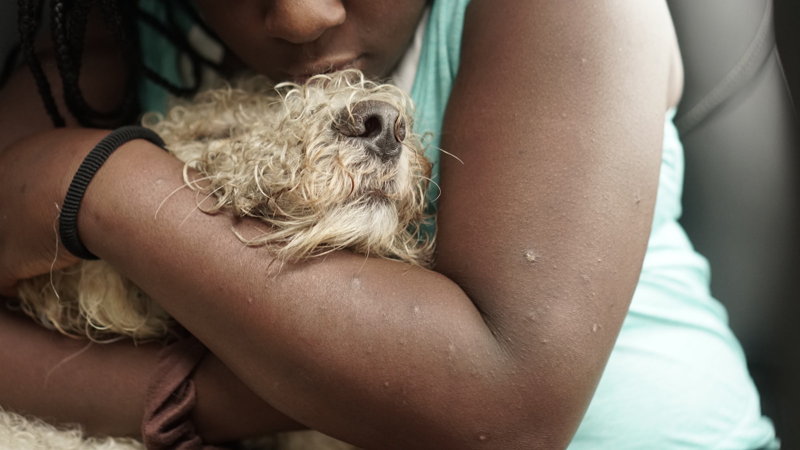 a woman holding a dog in her arms