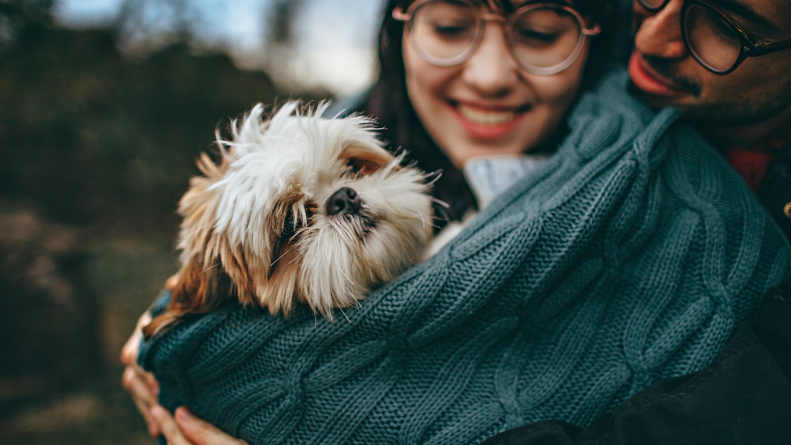 woman carrying dog